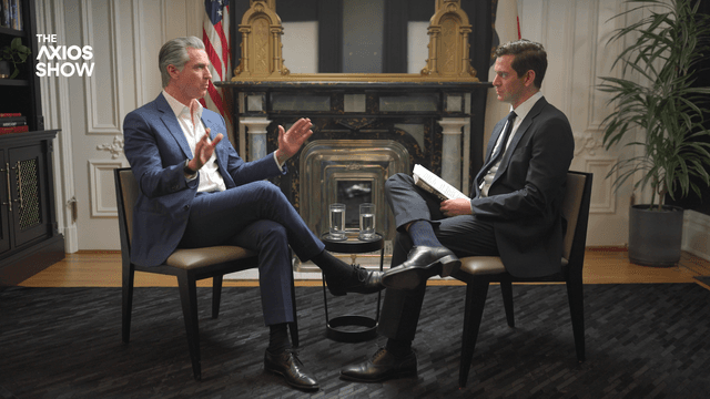 Gov. Gavin Newsom talks to Axios' Alex Thompson. Two men in suits in chairs.