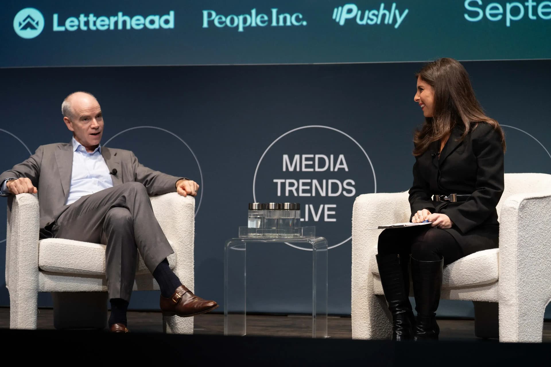 Image of two people sitting at an Axios Media Trends Live event stage